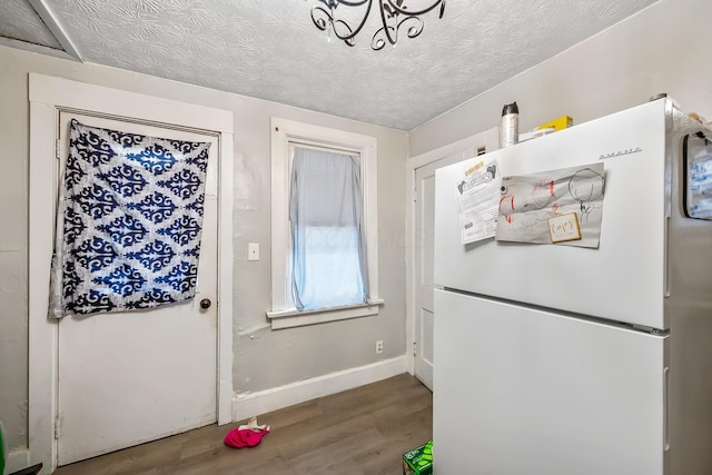 doorway to outside with hardwood / wood-style floors and a textured ceiling