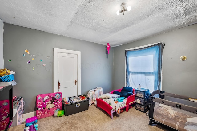 carpeted bedroom featuring a textured ceiling