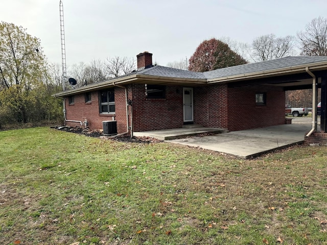 back of property featuring a patio, a yard, and central AC