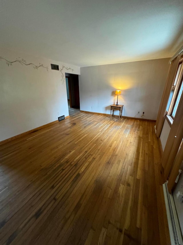 spare room with dark hardwood / wood-style floors