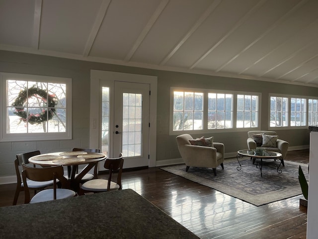 sunroom featuring vaulted ceiling with beams