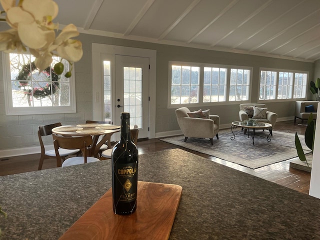 sunroom / solarium with vaulted ceiling with beams