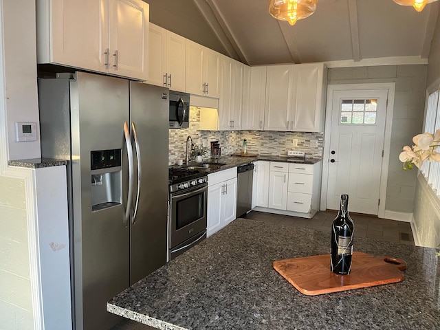 kitchen featuring backsplash, stainless steel appliances, sink, white cabinets, and lofted ceiling