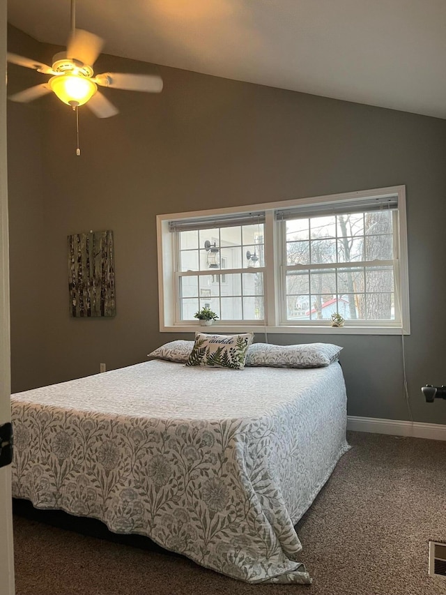 carpeted bedroom with ceiling fan and lofted ceiling