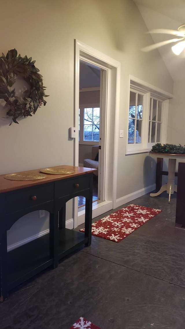 foyer with ceiling fan and lofted ceiling