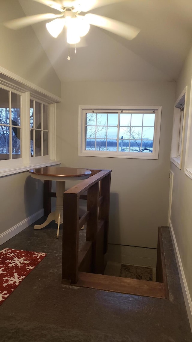 dining room featuring ceiling fan and lofted ceiling