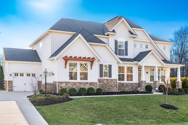 craftsman-style house with a garage and a front lawn