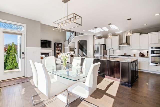 dining space with hardwood / wood-style floors and sink