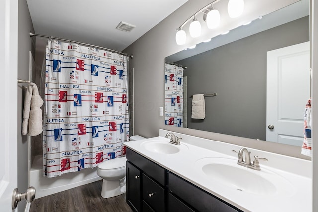 full bathroom with vanity, hardwood / wood-style flooring, toilet, and shower / bathtub combination with curtain