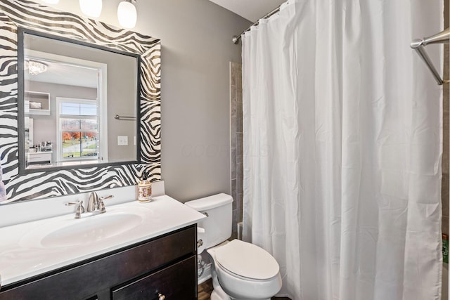 bathroom with vanity, a shower with shower curtain, and toilet