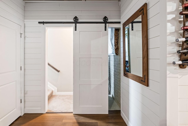 bathroom with hardwood / wood-style floors and wooden walls