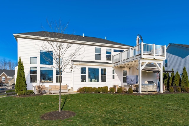 back of property with a lawn, an outdoor living space, and a balcony