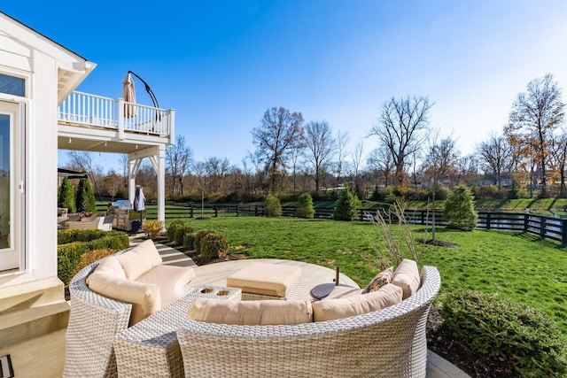 view of yard with an outdoor living space and a balcony