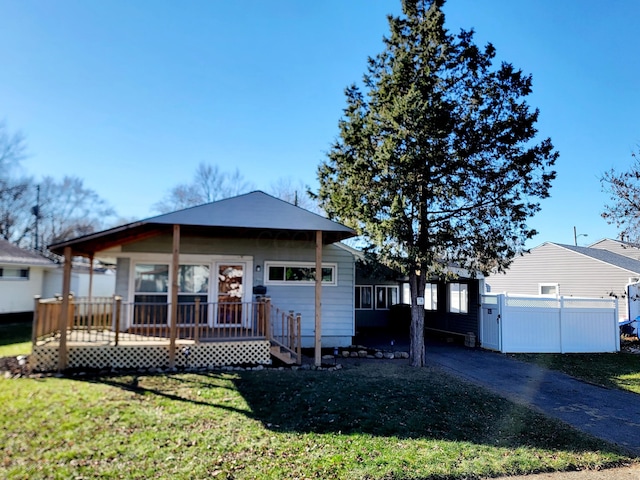 view of front of home with a porch and a front lawn