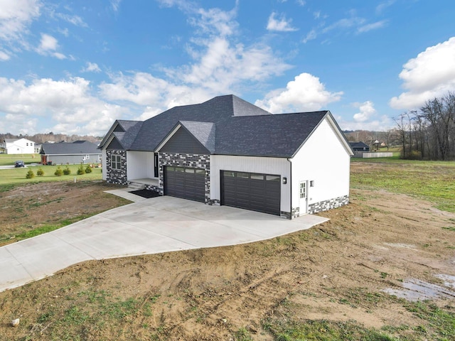 view of side of property featuring a garage and a lawn