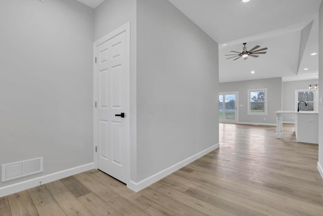 hallway featuring sink and light wood-type flooring