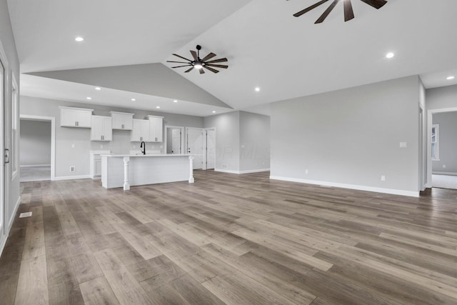 701 Colby Way, Newark, OH 43055 - unfurnished living room featuring a ceiling fan, recessed lighting, wood finished floors, and high vaulted ceiling