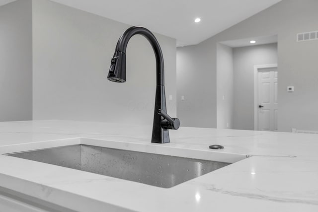 details featuring sink and light stone countertops