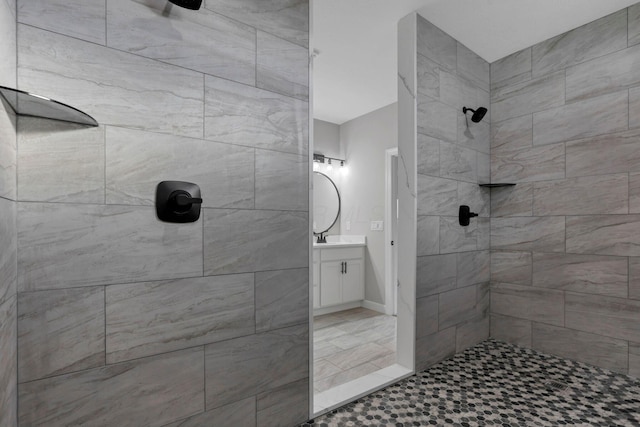 bathroom featuring vanity and a tile shower