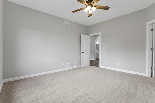 spare room featuring ceiling fan and carpet floors