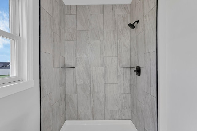 bathroom with tiled shower