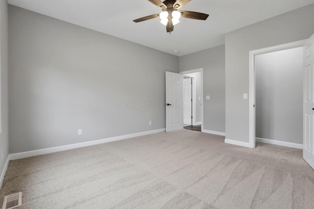 unfurnished bedroom featuring light colored carpet and ceiling fan