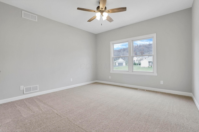 spare room featuring ceiling fan and carpet flooring