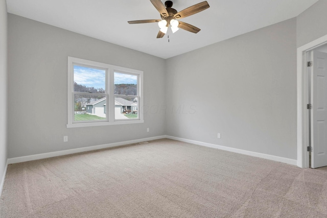 carpeted empty room with ceiling fan