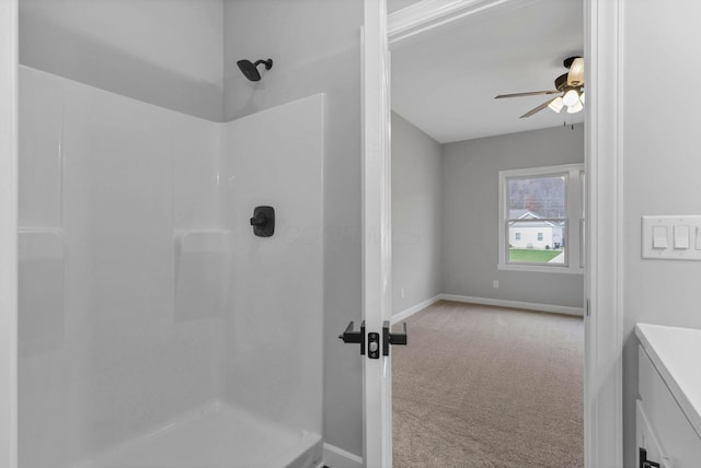 bathroom featuring walk in shower, ceiling fan, and vanity