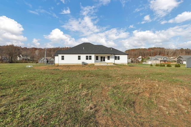 back of house with a lawn