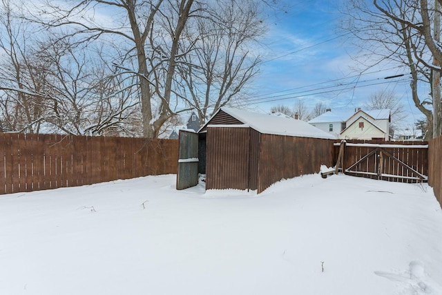 yard covered in snow featuring an outdoor structure