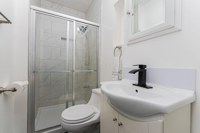 bathroom featuring a textured ceiling, vanity, an enclosed shower, and toilet