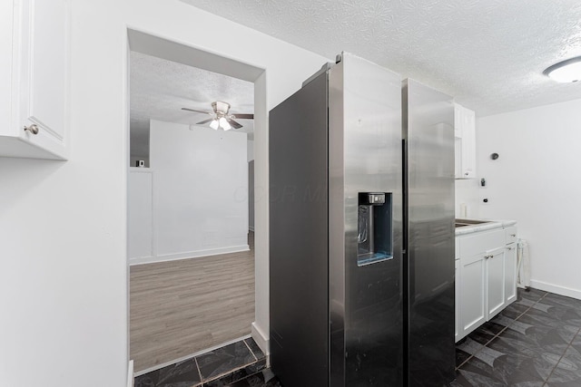 kitchen featuring a textured ceiling, ceiling fan, white cabinetry, and stainless steel refrigerator with ice dispenser