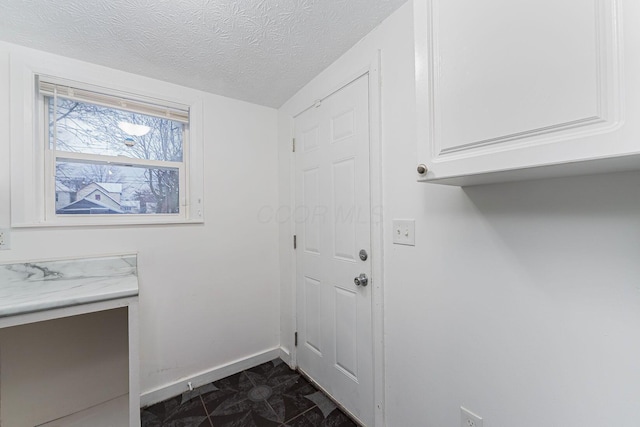 laundry area featuring a textured ceiling