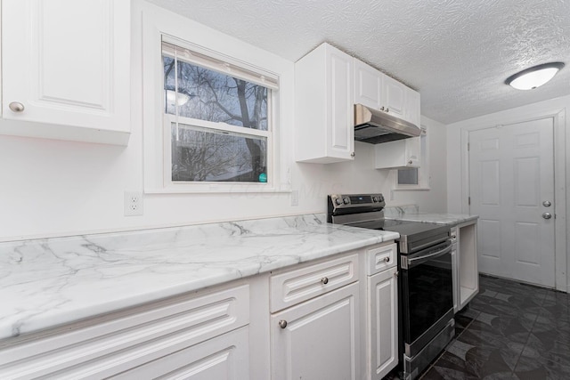 kitchen featuring light stone countertops, a textured ceiling, electric range, and white cabinetry