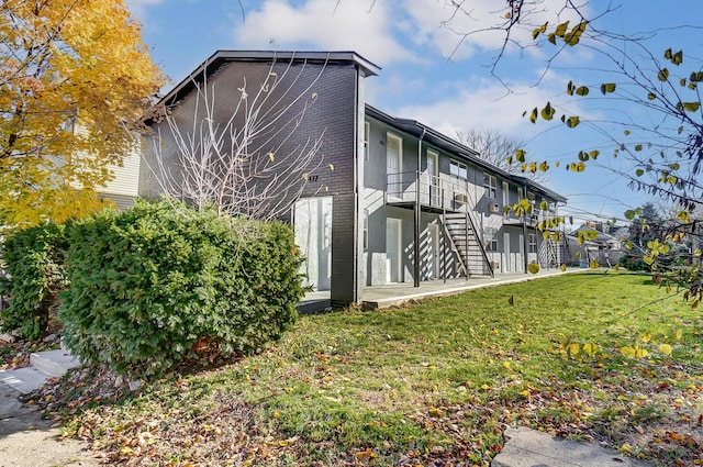 view of property exterior featuring a lawn