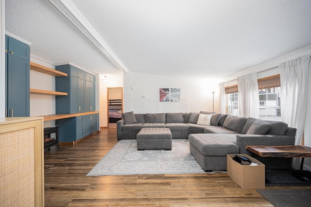 living room with dark wood-type flooring and a textured ceiling