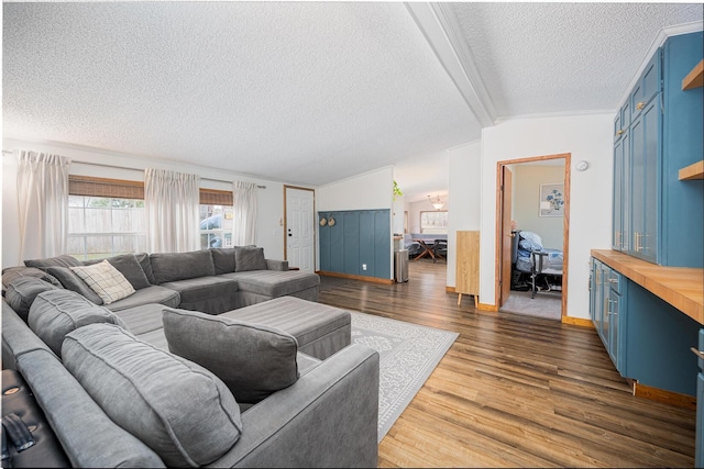 living room featuring dark hardwood / wood-style flooring, vaulted ceiling with beams, a textured ceiling, and crown molding