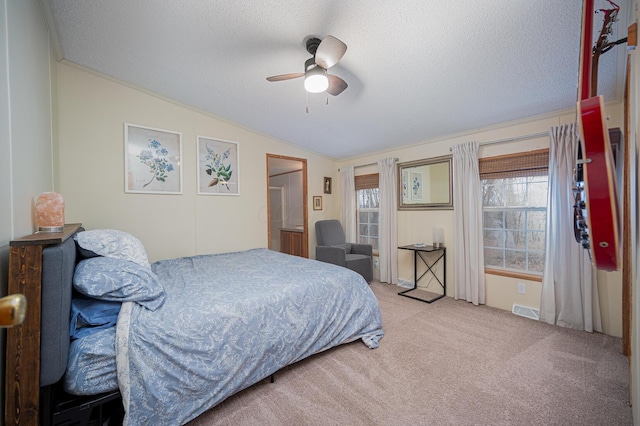 carpeted bedroom featuring a textured ceiling, ceiling fan, and lofted ceiling