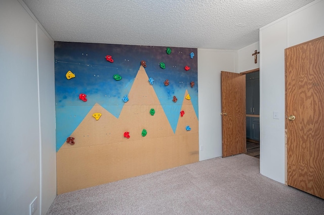 unfurnished bedroom with carpet and a textured ceiling