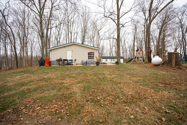 view of yard with a playground and a patio area