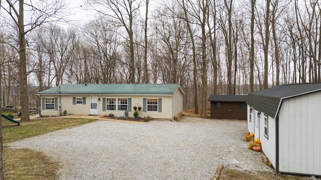 ranch-style house featuring a storage unit and a front yard