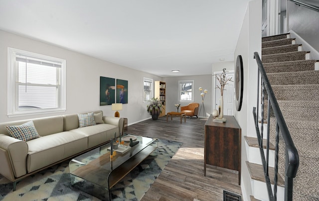 living room featuring plenty of natural light and dark wood-type flooring