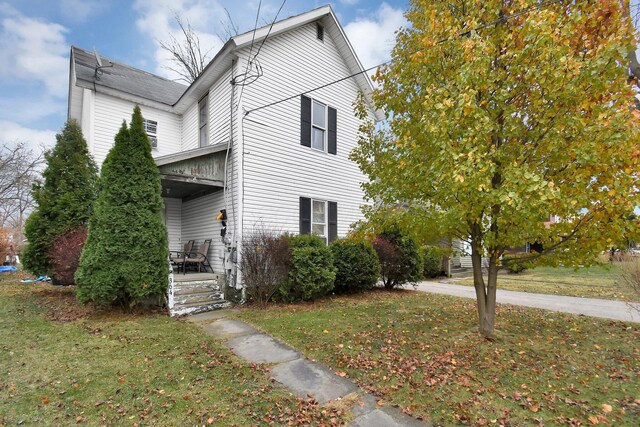 view of property exterior with a yard