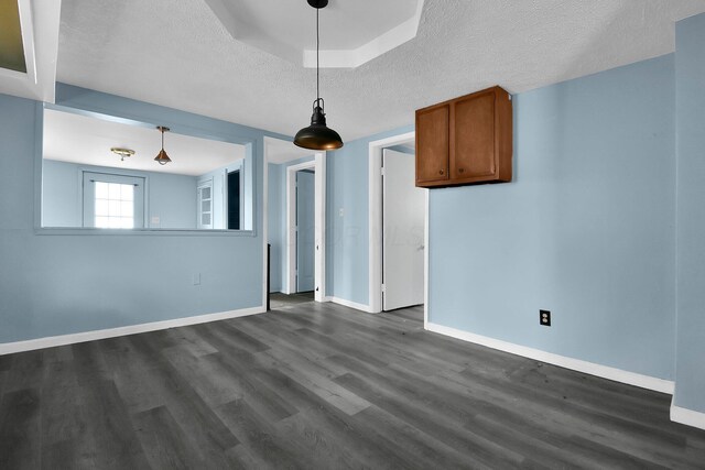 interior space with a textured ceiling and dark hardwood / wood-style floors