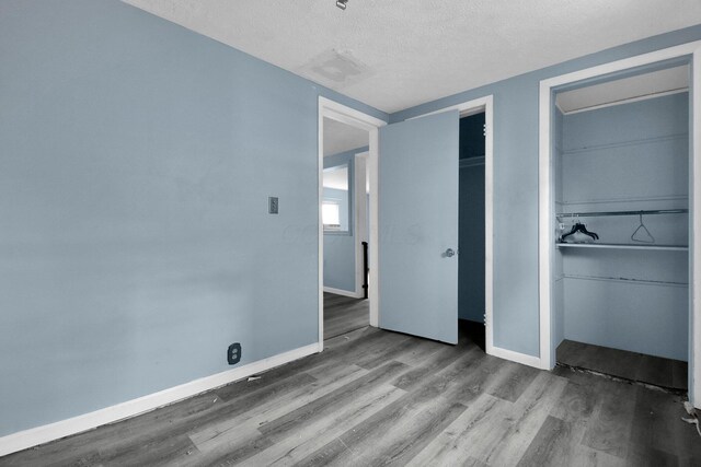 unfurnished bedroom featuring a textured ceiling and hardwood / wood-style flooring