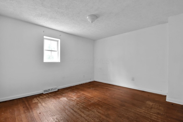 spare room with wood-type flooring and a textured ceiling