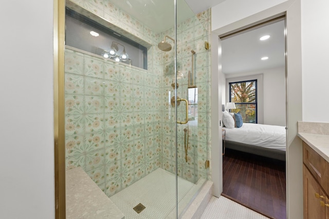 bathroom featuring tile patterned flooring, vanity, and a shower with door