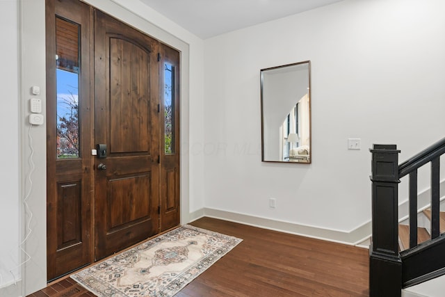 foyer entrance with dark hardwood / wood-style flooring