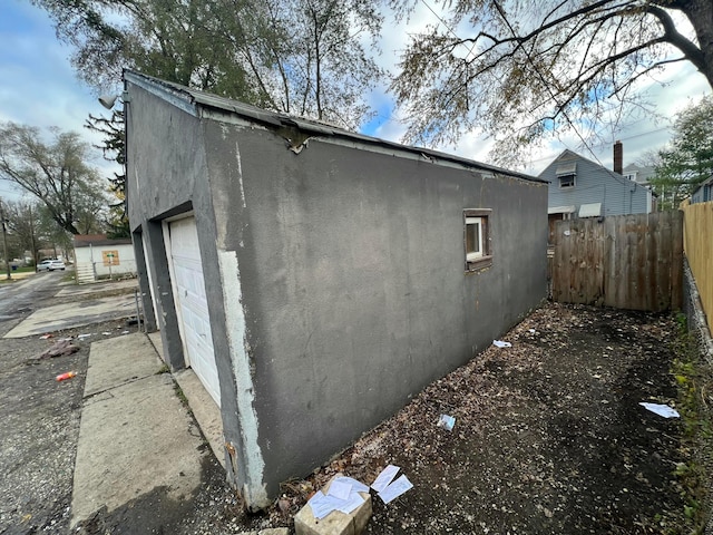 view of property exterior with an outbuilding and a garage